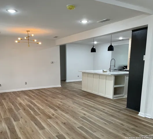 a view of a kitchen from the hallway