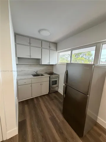 a kitchen with a refrigerator a sink and a stove