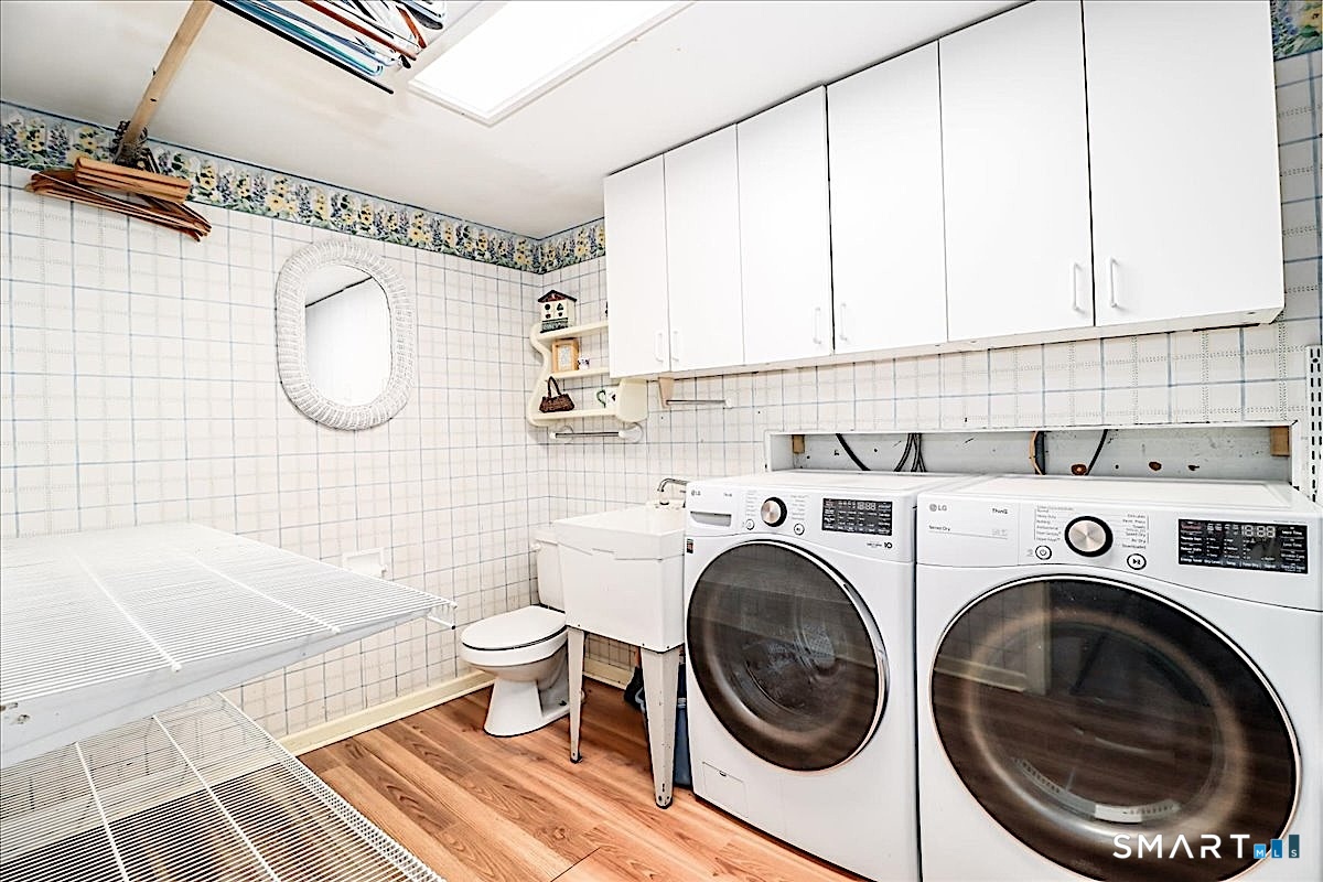 3 Hawthorne Hill Road Newtown, CT 06470 - Photo 31 of 40 Convenient Half Bath and Laundry Room with Abundant Storage and Shelving
