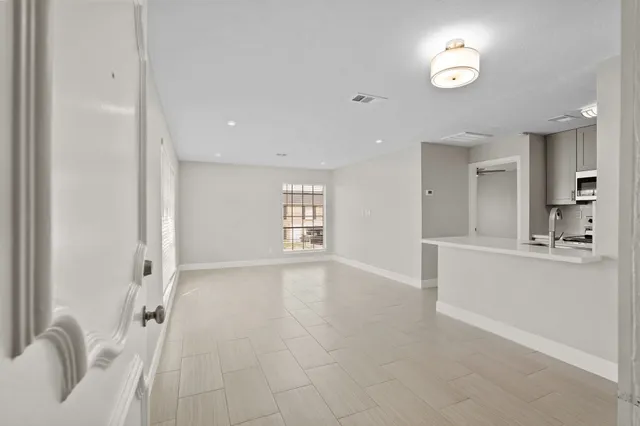 a view of kitchen with kitchen island and stainless steel appliances