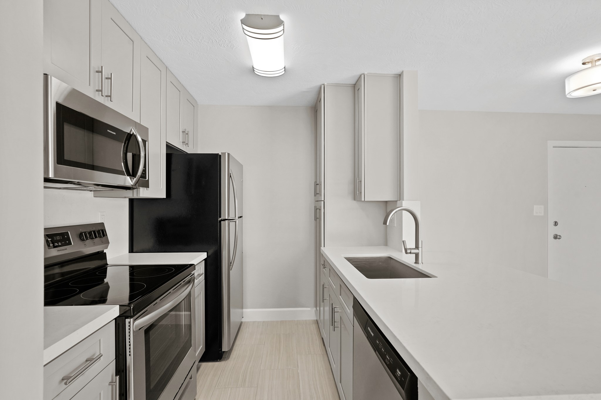 2101 Fountain View Drive, Unit 2 8 Houston, TX 77057 - Photo 8 of 16 a kitchen with stainless steel appliances a refrigerator sink and microwave