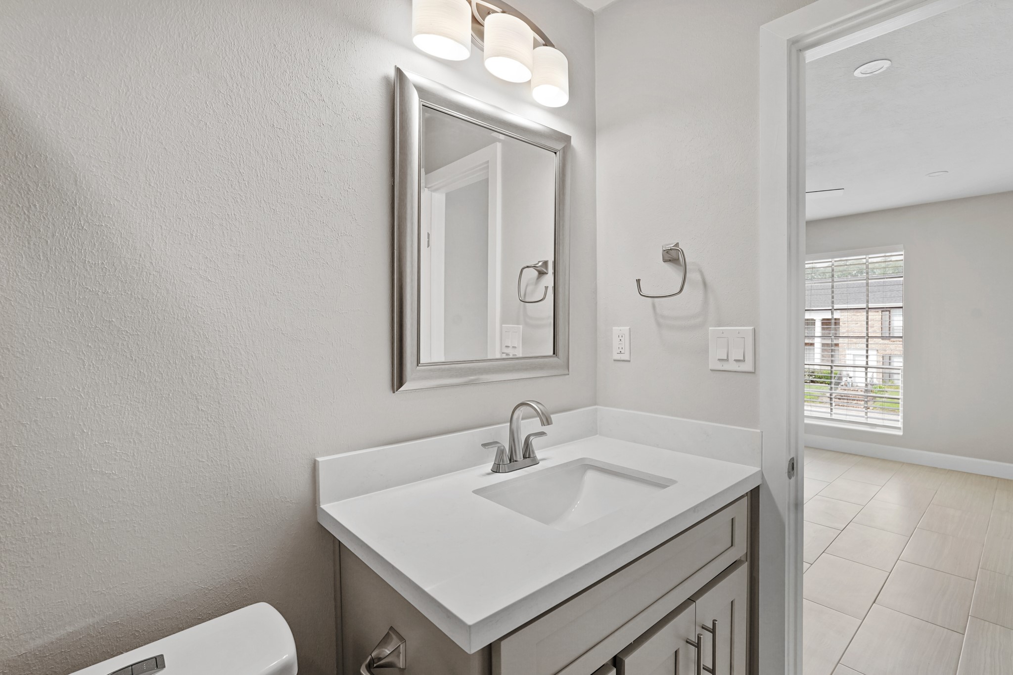 2101 Fountain View Drive, Unit 2 8 Houston, TX 77057 - Photo 9 of 16 a bathroom with a sink vanity and a mirror