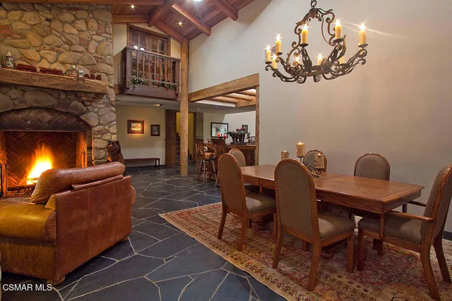 a living room with furniture a chandelier and a fireplace