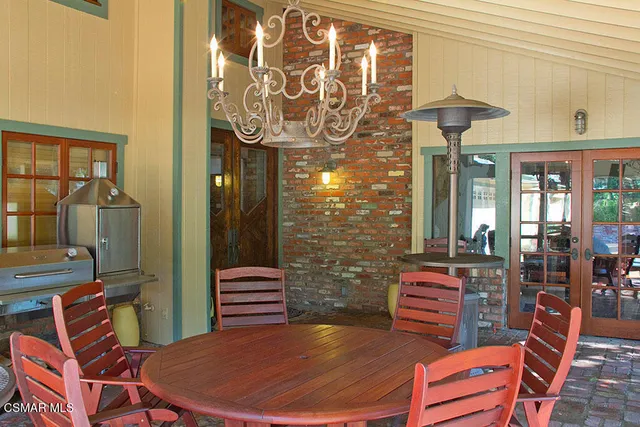 a balcony with table and chairs