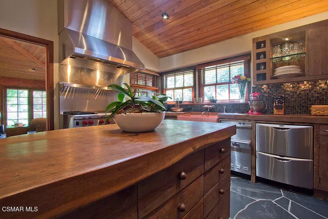a kitchen with stainless steel appliances a sink dishwasher stove and refrigerator