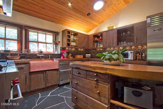 a kitchen with stainless steel appliances granite countertop a stove and a sink
