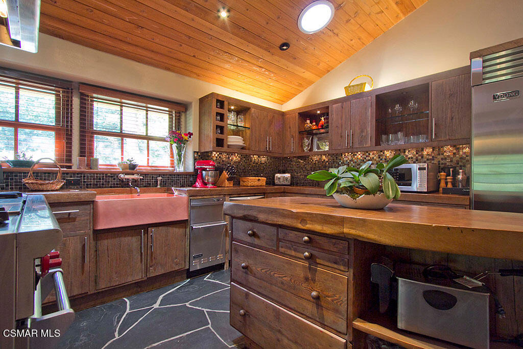 1812 West Potrero Road Thousand Oaks, CA 91361 - Photo 23 of 35 a kitchen with stainless steel appliances granite countertop a stove and a sink