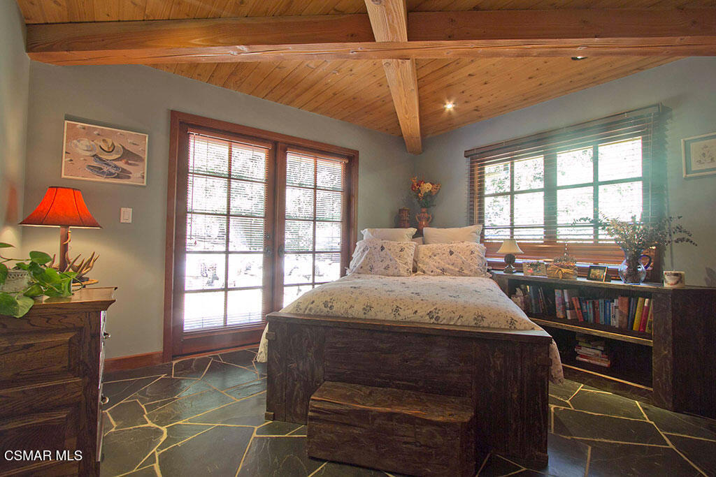 1812 West Potrero Road Thousand Oaks, CA 91361 - Photo 33 of 35 a bedroom with a bed a chandelier and a window