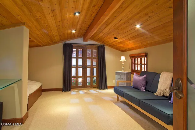 a spacious bedroom with a bed and a chandelier