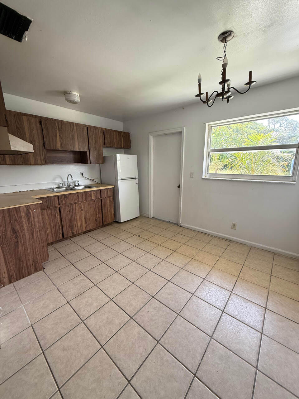 1794 Juno Road, Unit 5 North Palm Beach, FL 33408 - Photo 2 of 6 a view of kitchen with furniture and window
