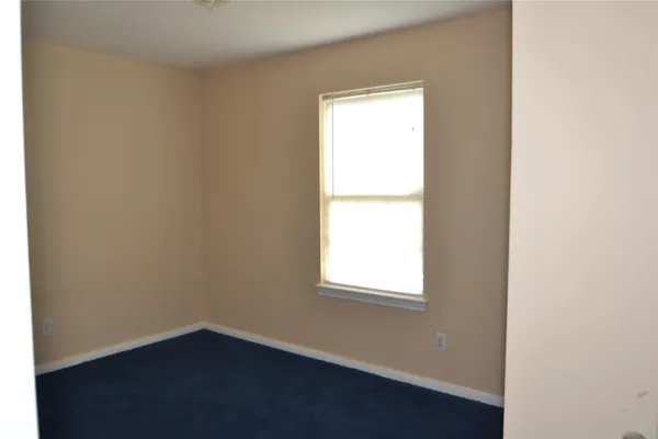 a view of a house with backyard and a tree