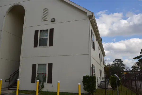 a view of staircase with wooden floor and white walls