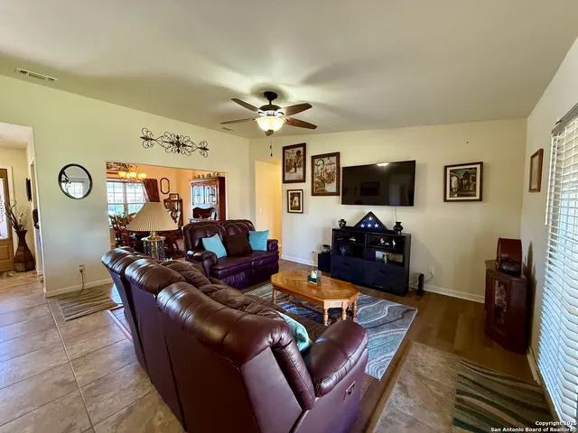 a living room with furniture workspace and a flat screen tv