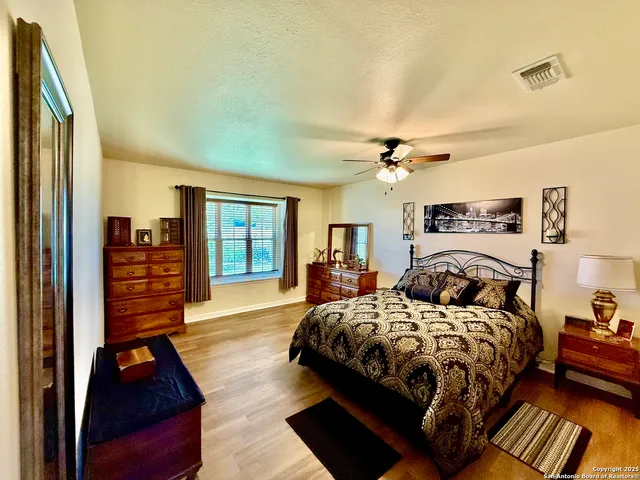 a bedroom with double bed and a chandelier