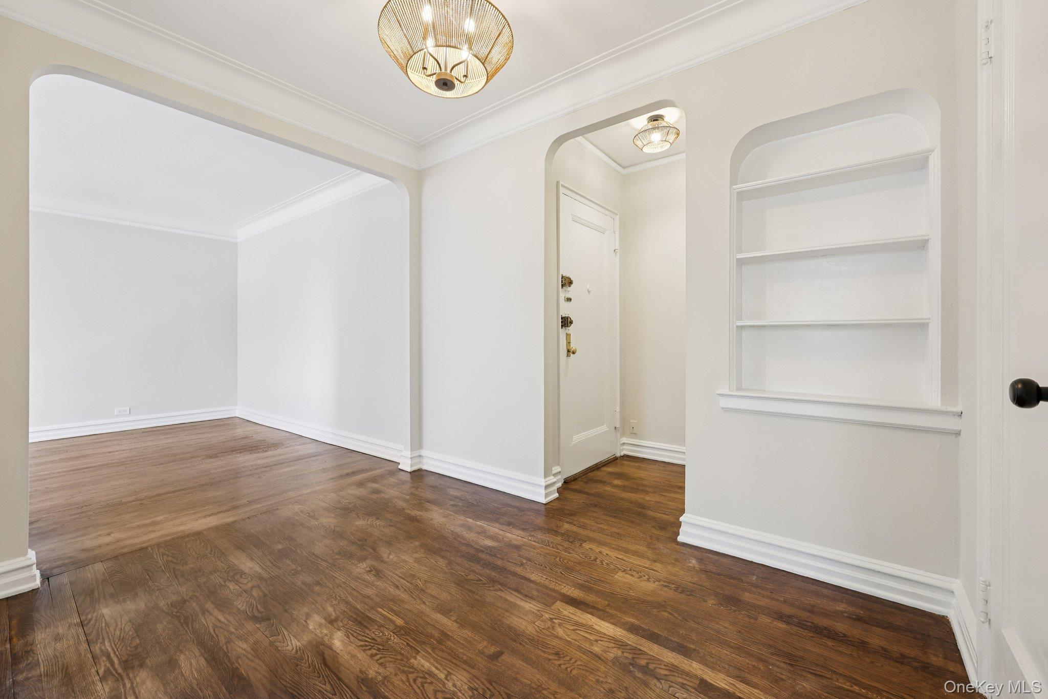 1 Bronxville Road, Unit 3S Bronxville, NY 10708 - Photo 21 of 27 Entrance foyer with dark wood-type flooring, crown molding, and arched walkways