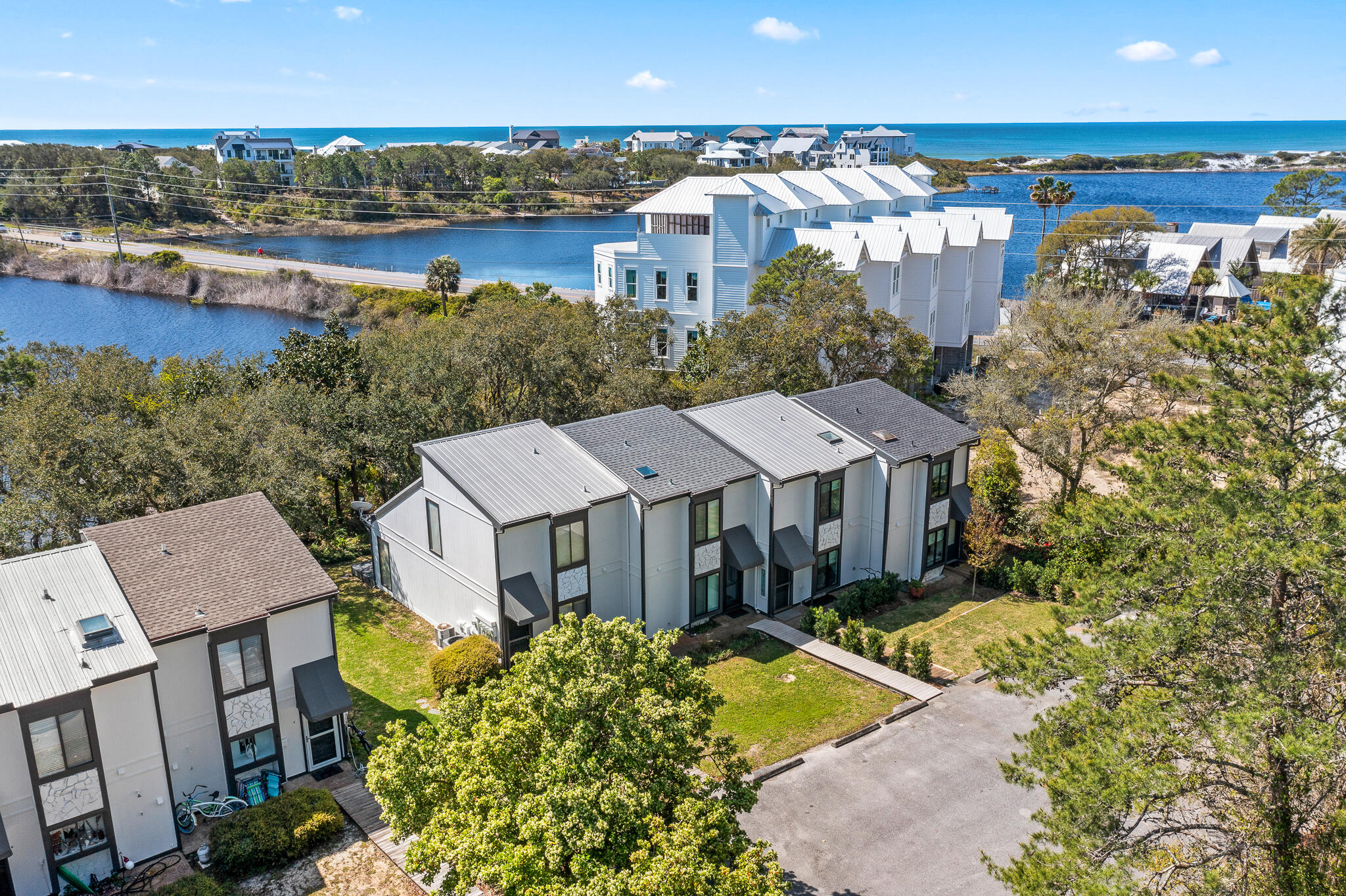 70 North Camp Creek Rd Inlet Beach, Unit 3 Inlet Beach, FL 32461 - Photo 5 of 66 an aerial view of a house with a garden and lake view