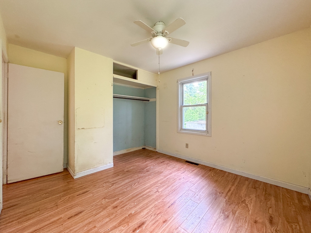 515 Rounseville Road Rochester, MA 02770 - Photo 15 of 18 an empty room with wooden floor and windows
