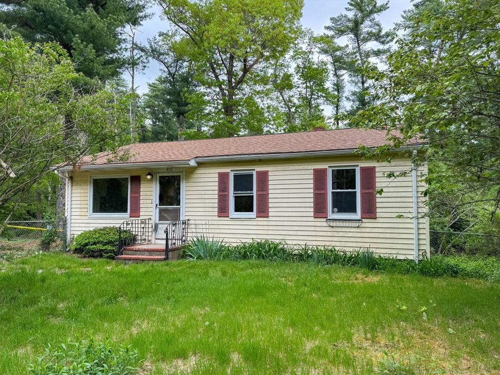 515 Rounseville Road Rochester, MA 02770 - Photo 3 of 18 a front view of a house with a yard and a tree