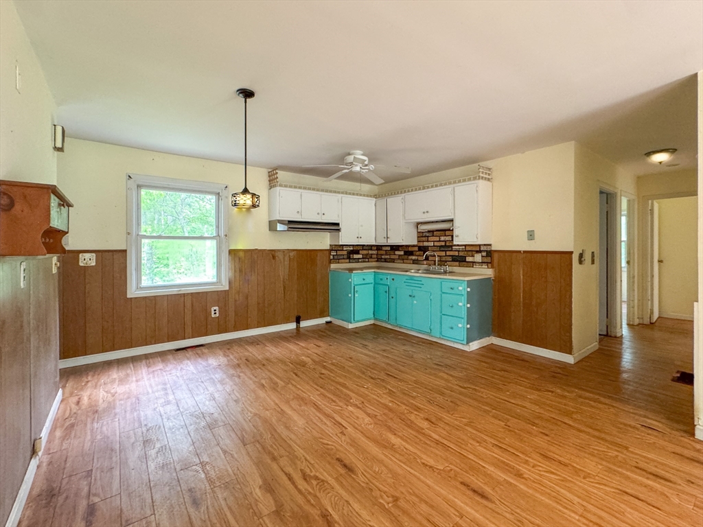 515 Rounseville Road Rochester, MA 02770 - Photo 5 of 18 a view of a kitchen with wooden floor and windows