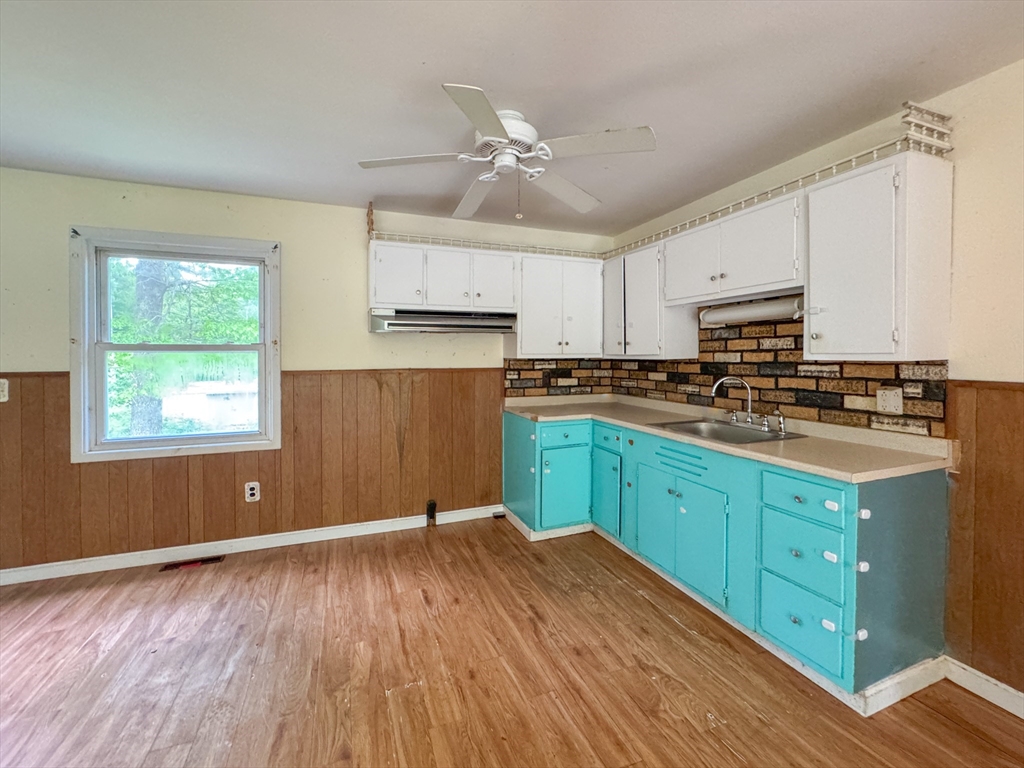 515 Rounseville Road Rochester, MA 02770 - Photo 8 of 18 a kitchen with wooden floors and wooden cabinets