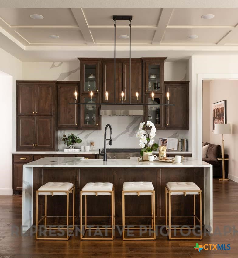 5727 Ryder Road New Braunfels, TX 78130 - Photo 2 of 18 a kitchen with cabinets and chairs