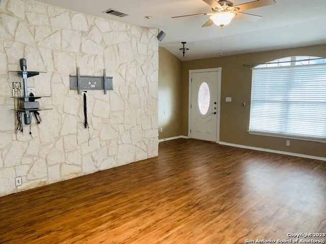 wooden floor in an empty room with a window