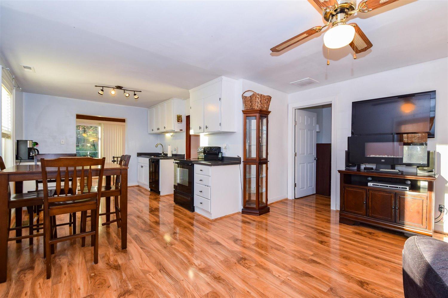 6306 Roberta Road Roanoke, VA 24019 - Photo 1 of 27 a kitchen with stainless steel appliances granite countertop a refrigerator a stove top oven a sink dishwasher and a dining table with wooden floor