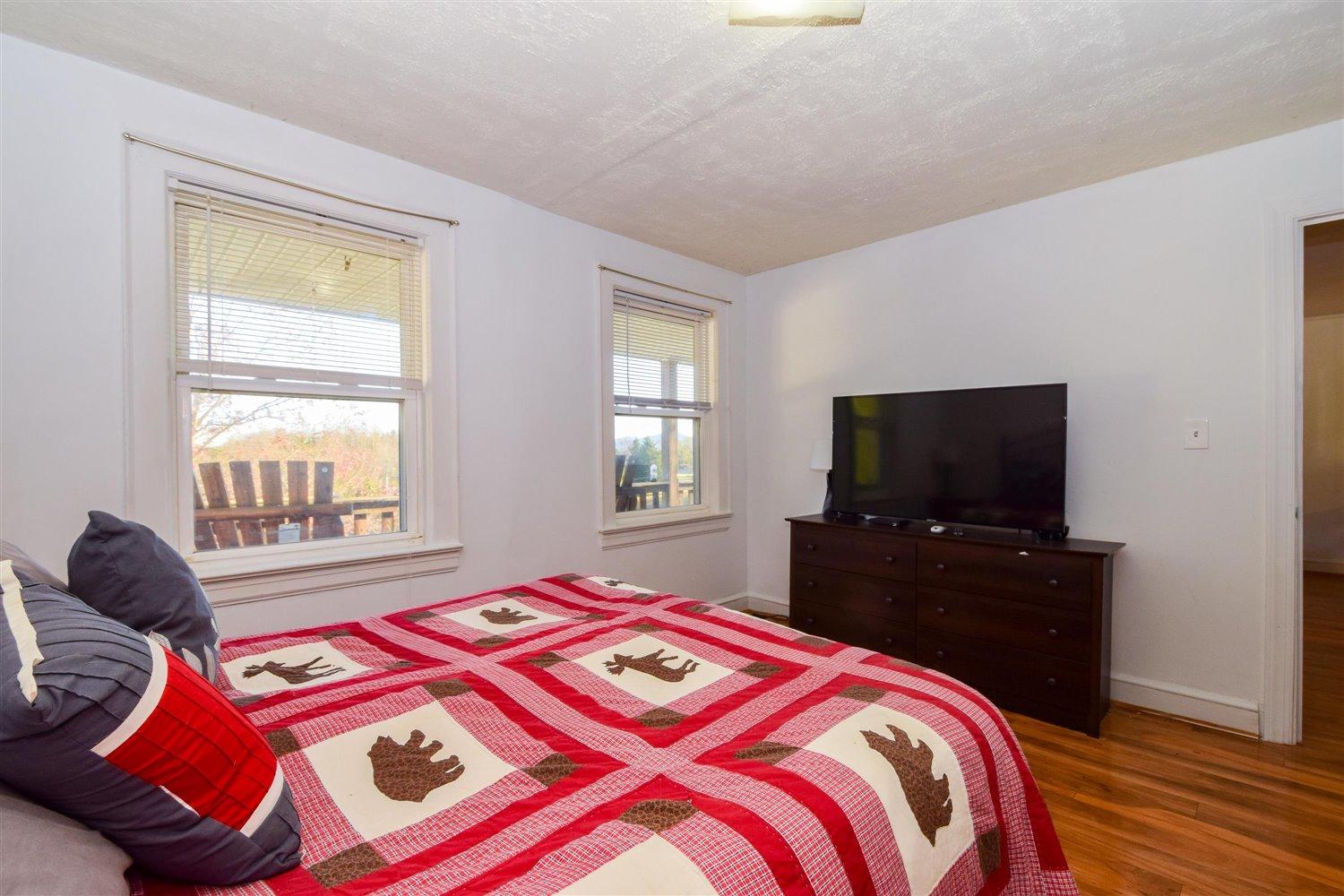 6306 Roberta Road Roanoke, VA 24019 - Photo 15 of 27 a bedroom with a bed and a flat tv screen on dresser