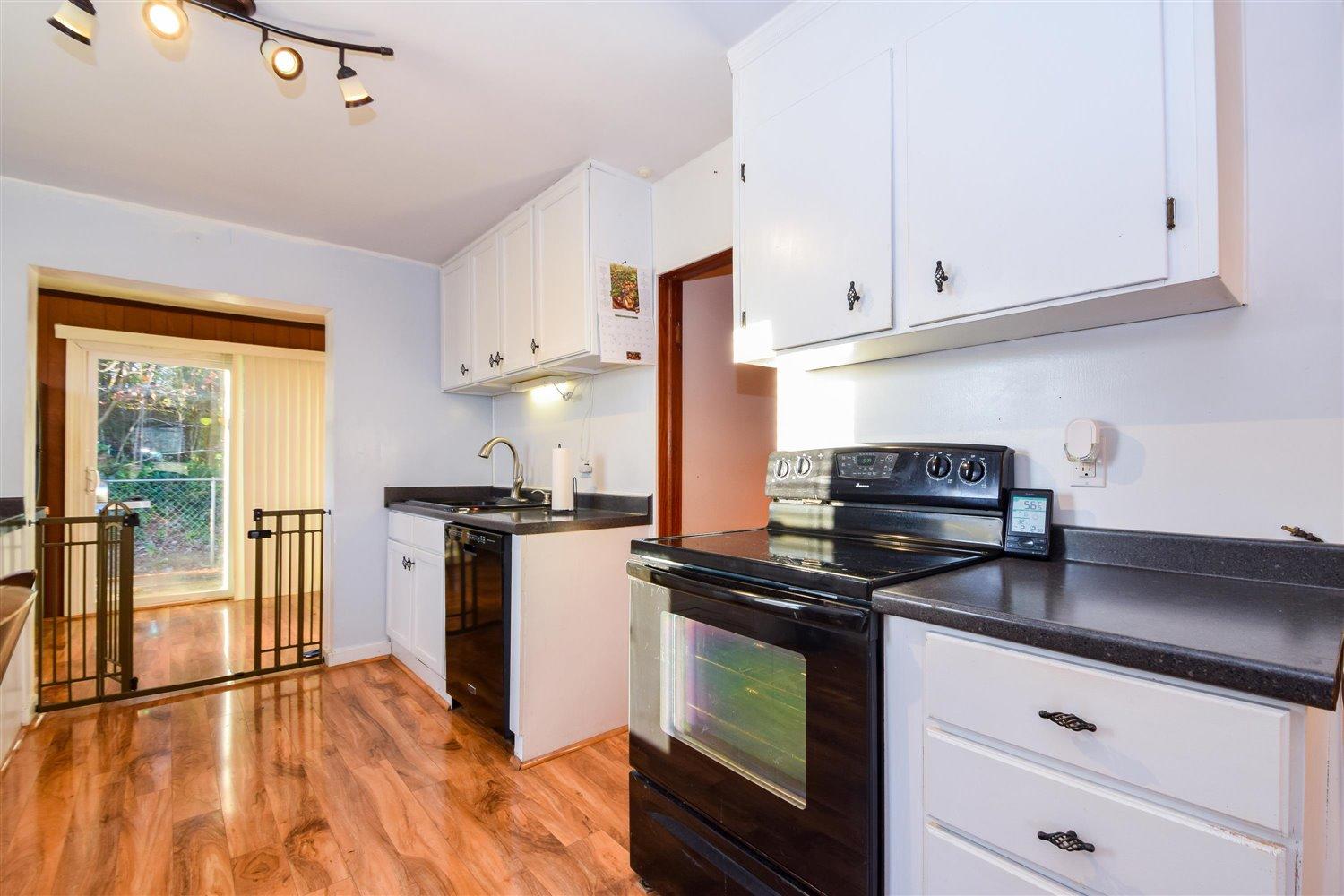 6306 Roberta Road Roanoke, VA 24019 - Photo 10 of 27 a kitchen with stainless steel appliances granite countertop a stove and a refrigerator