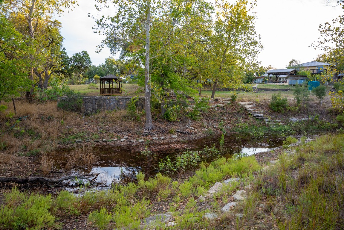12737 Silver Creek Road Dripping Springs, TX 78620 - Photo 10 of 36 a backyard of a house with a yard and outdoor seating