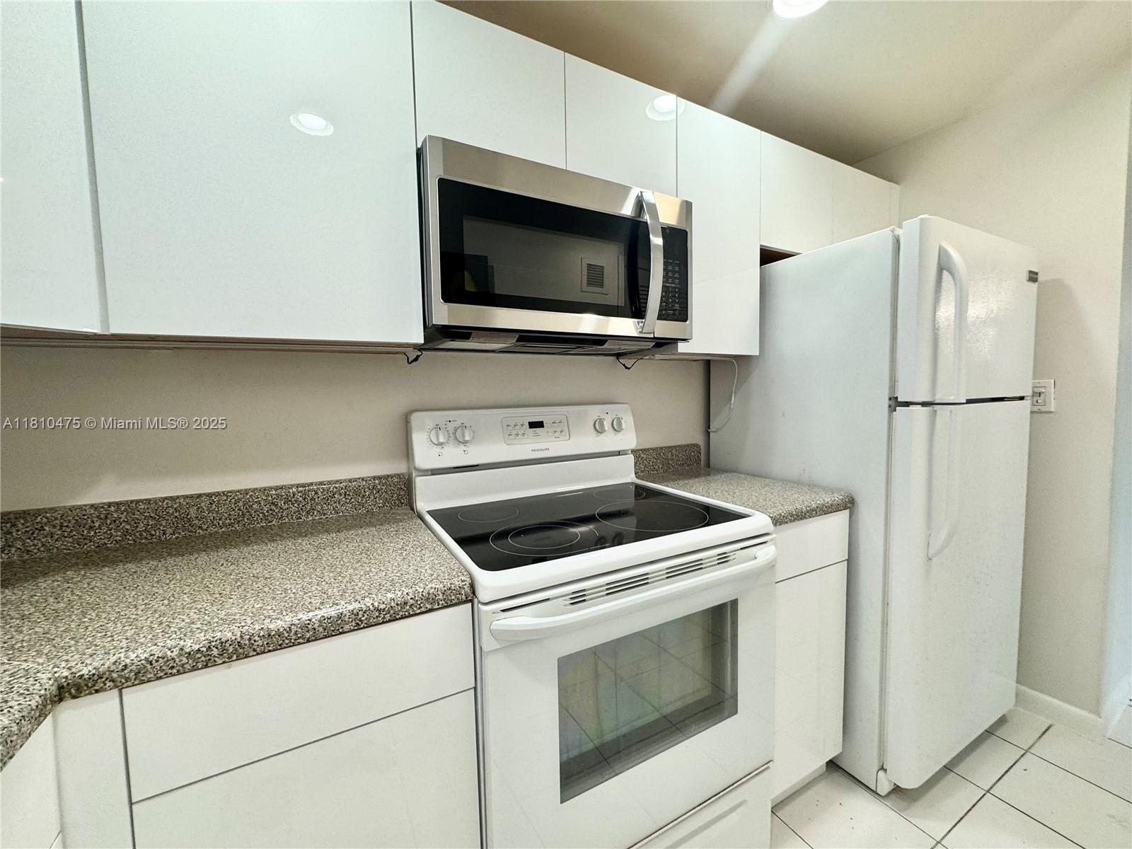 200 South Birch Road, Unit 304 Fort Lauderdale, FL 33316 - Photo 2 of 16 a kitchen with a stove and a microwave
