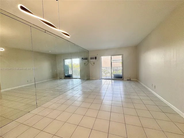 a view of empty room with window and fireplace