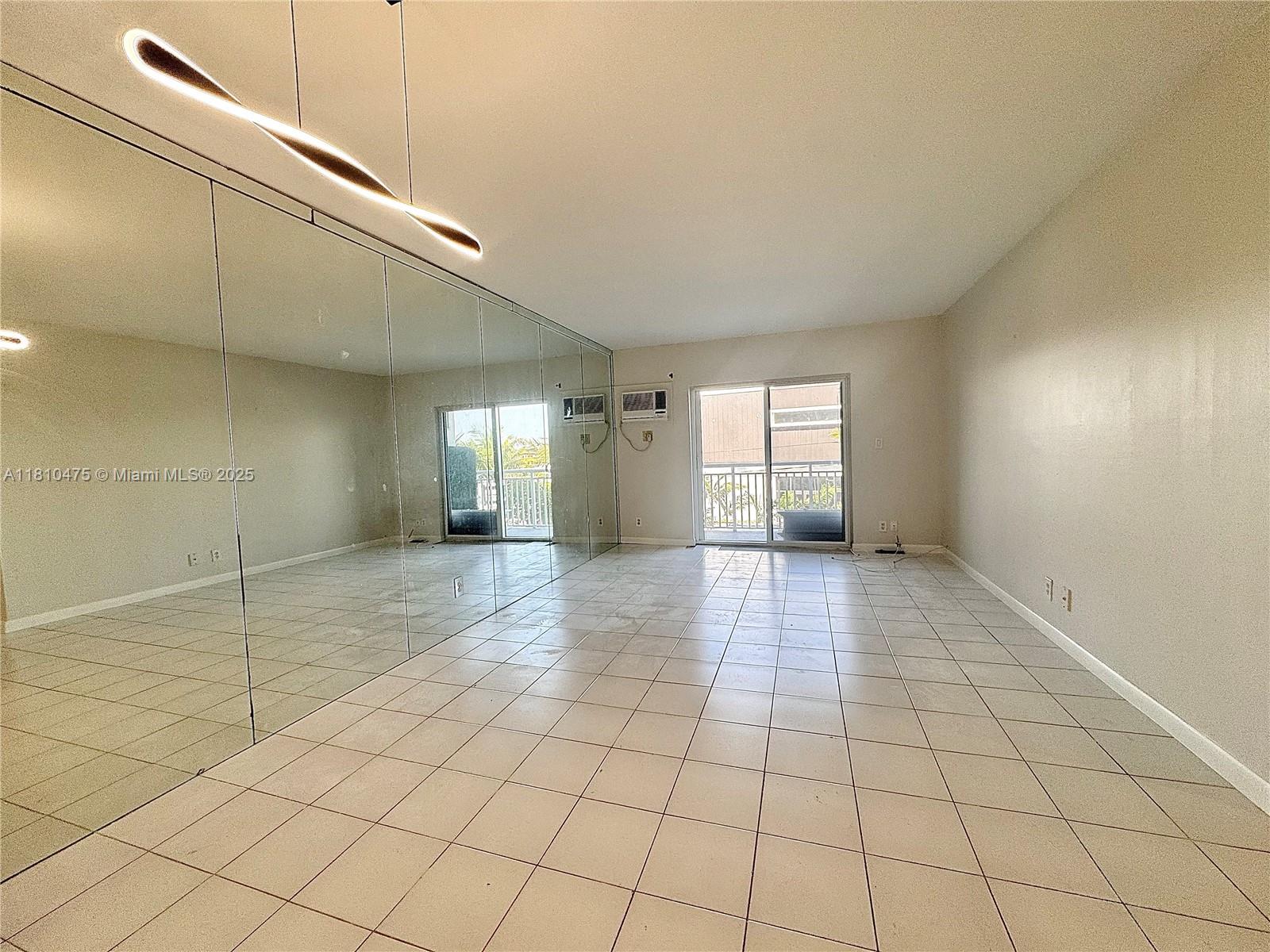 200 South Birch Road, Unit 304 Fort Lauderdale, FL 33316 - Photo 5 of 16 a view of empty room with window and fireplace