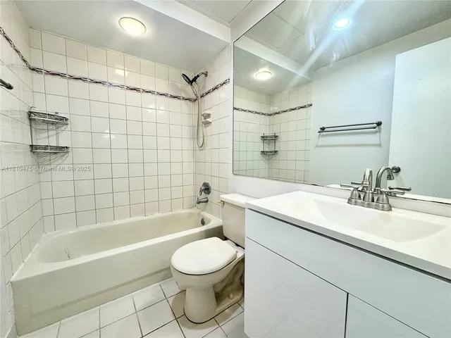 a bathroom with a sink a toilet and bathtub