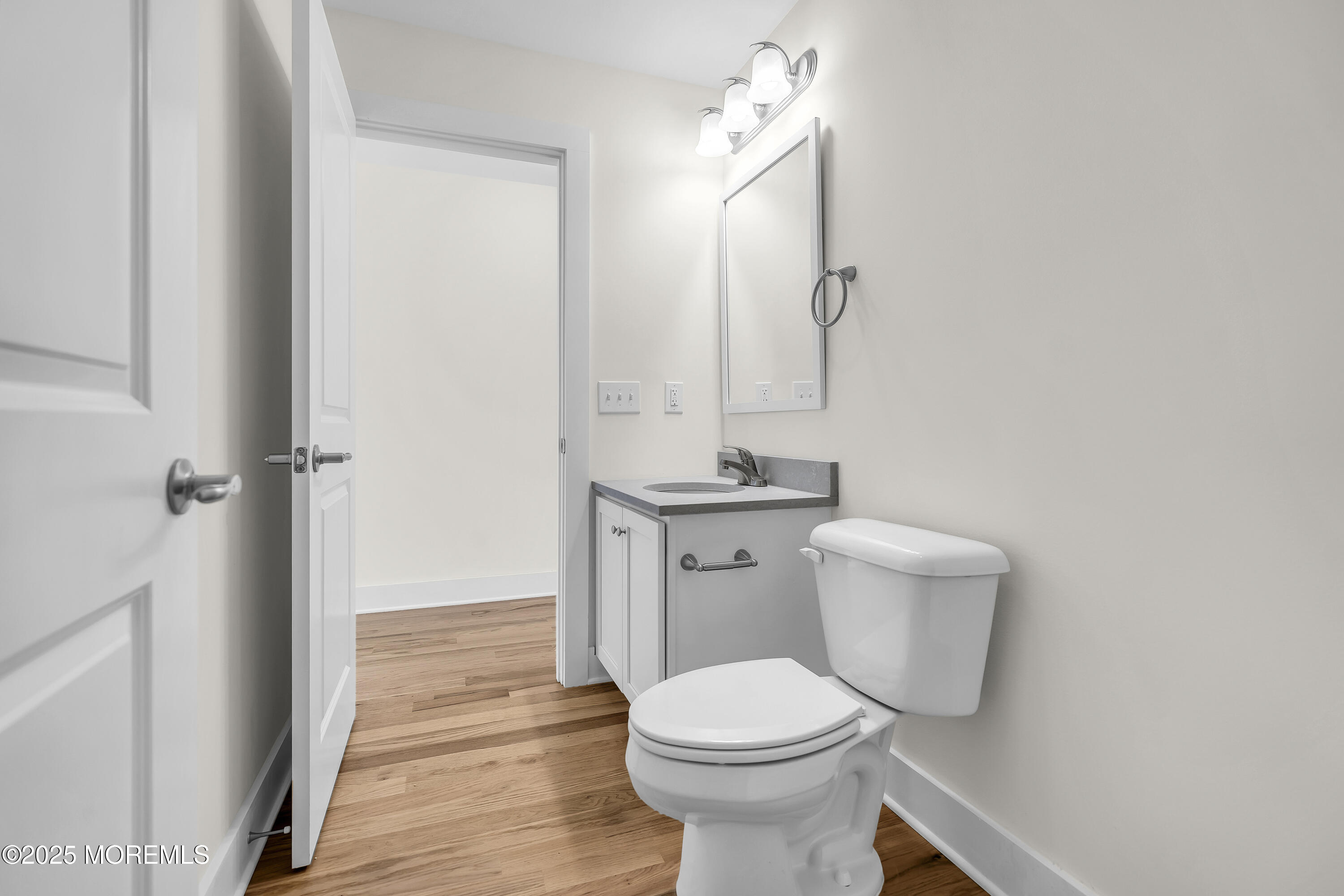 604 Ocean Road Point Pleasant, NJ 08742 - Photo 13 of 15 a bathroom with a toilet a sink and mirror