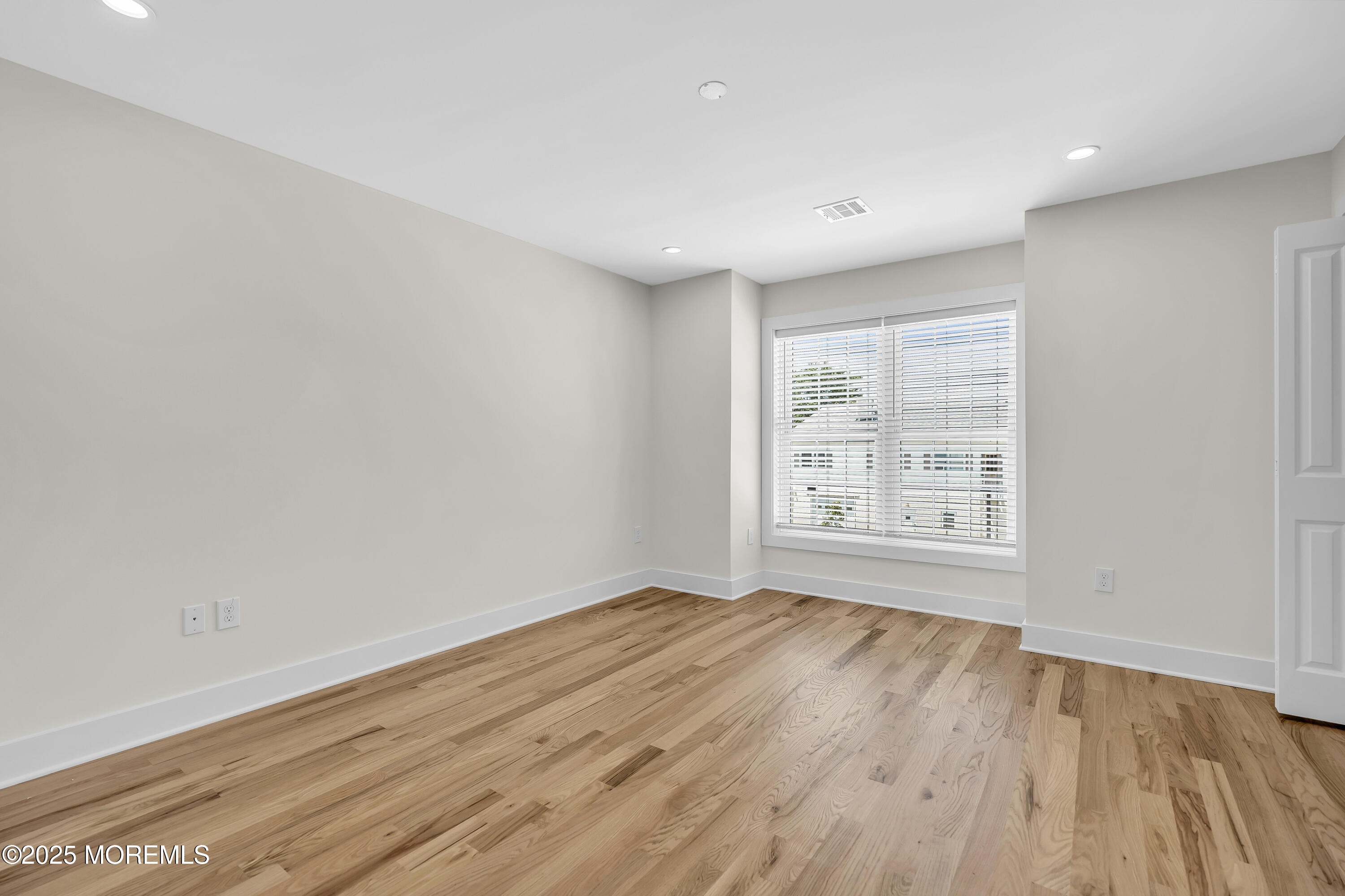 604 Ocean Road Point Pleasant, NJ 08742 - Photo 5 of 15 a view of an empty room with wooden floor and a window