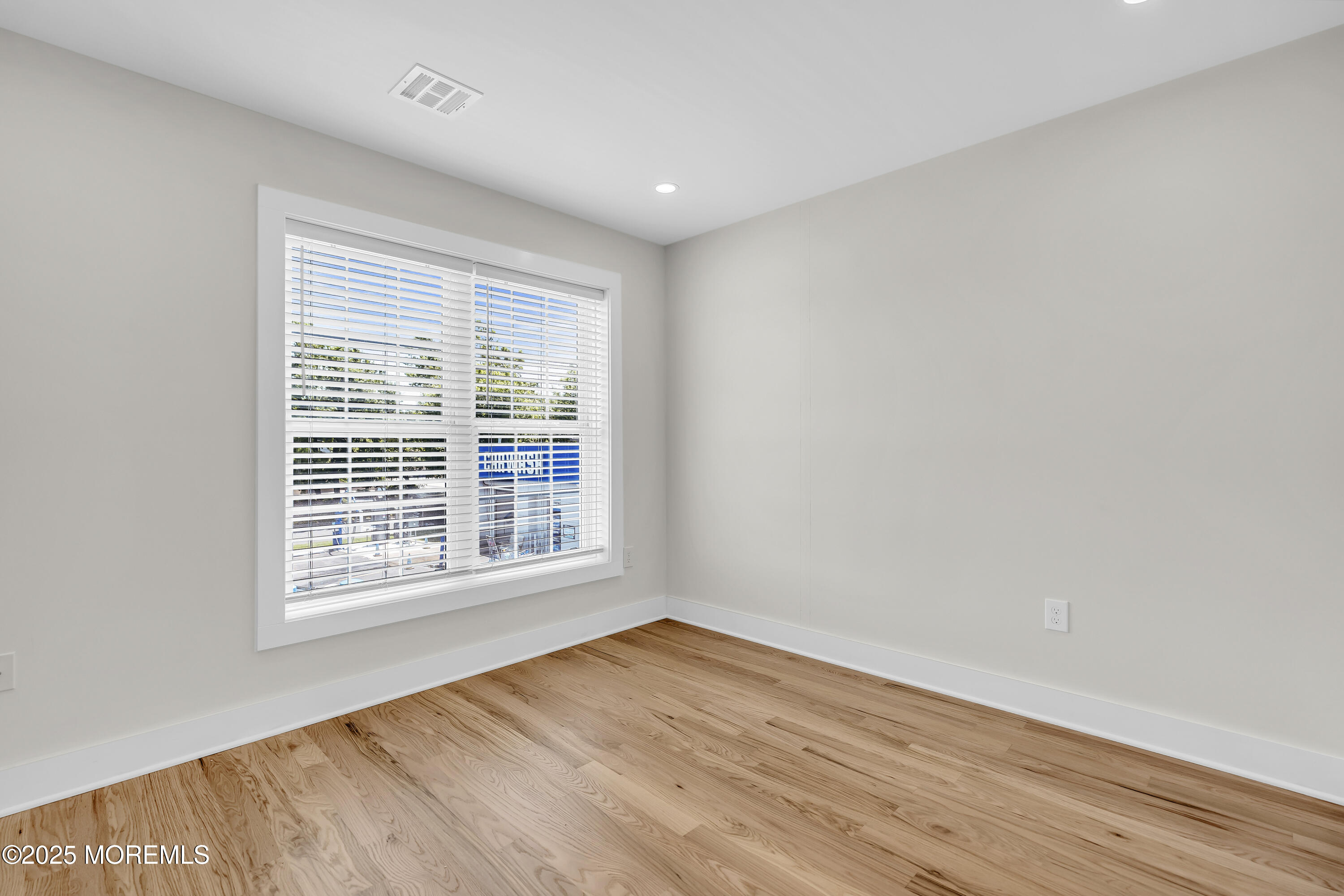 604 Ocean Road Point Pleasant, NJ 08742 - Photo 7 of 15 a view of an empty room with wooden floor and a window