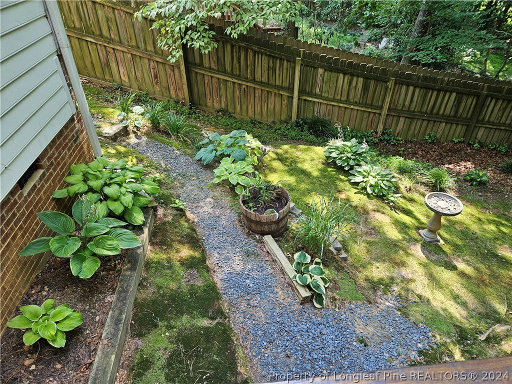 2825 Isabella Drive Raleigh, NC 27603 - Photo 14 of 31 a garden with trees in front of it