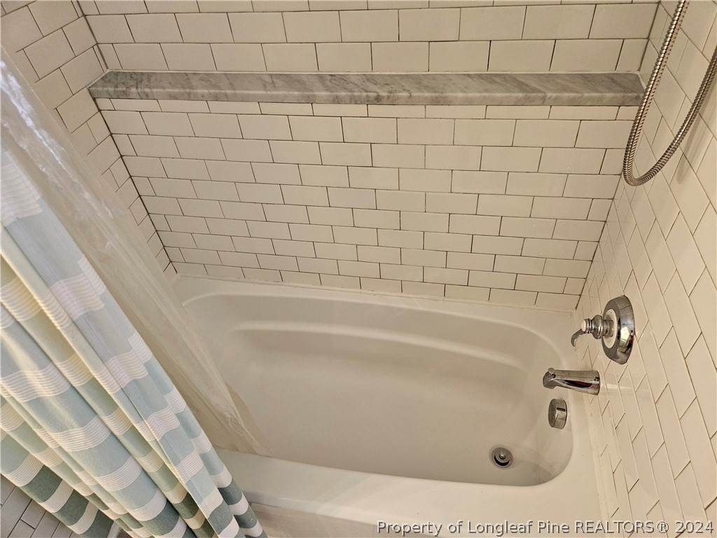 2825 Isabella Drive Raleigh, NC 27603 - Photo 23 of 31 a bathroom with a bathtub