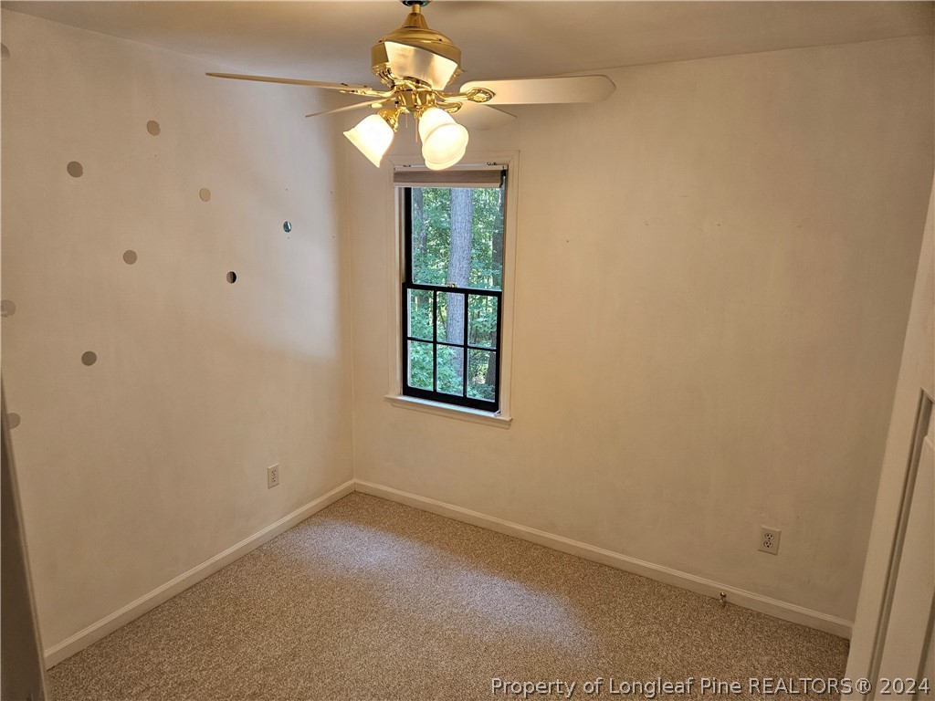 2825 Isabella Drive Raleigh, NC 27603 - Photo 24 of 31 an empty room with windows and fan
