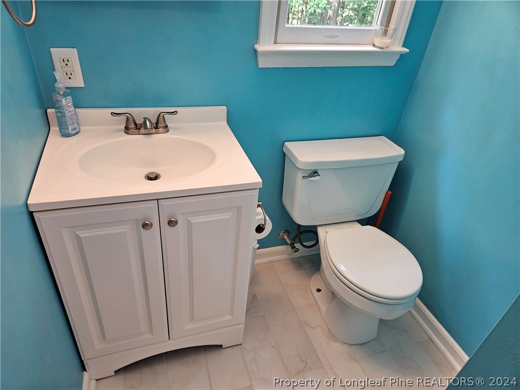 2825 Isabella Drive Raleigh, NC 27603 - Photo 26 of 31 a bathroom with a toilet sink and mirror