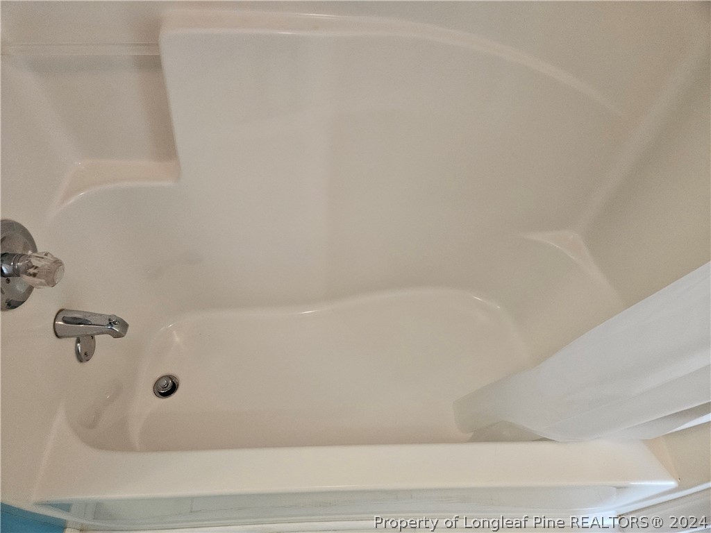 2825 Isabella Drive Raleigh, NC 27603 - Photo 27 of 31 a bathroom with a bathtub