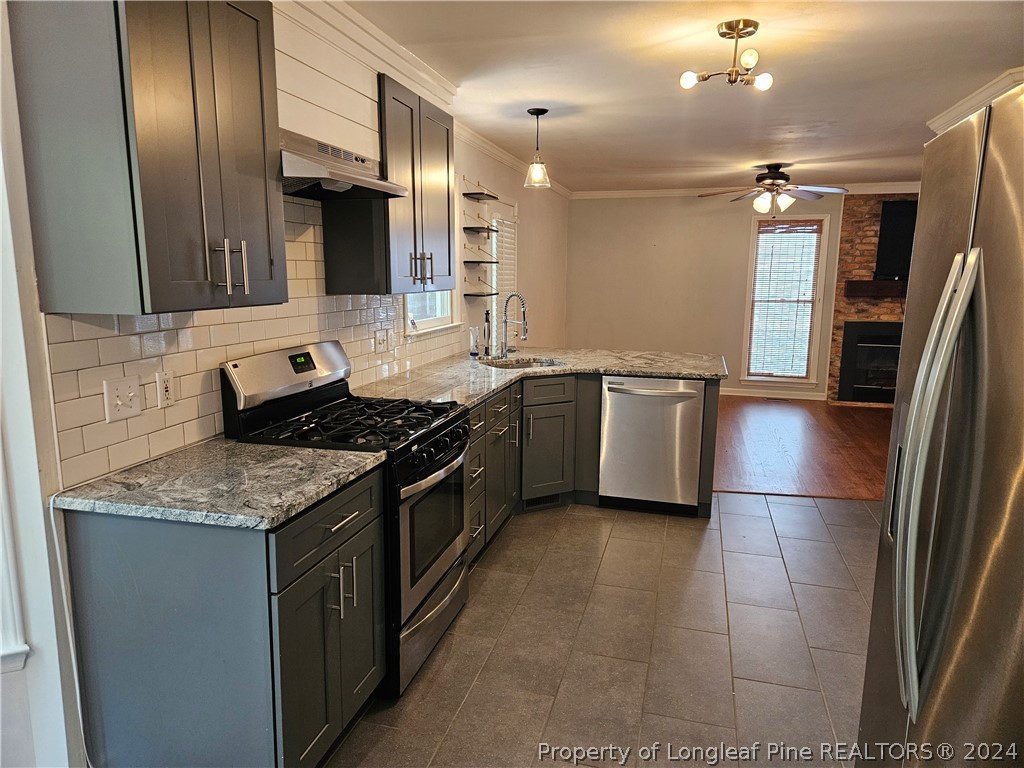 2825 Isabella Drive Raleigh, NC 27603 - Photo 9 of 31 a kitchen with stainless steel appliances granite countertop a sink stove and refrigerator