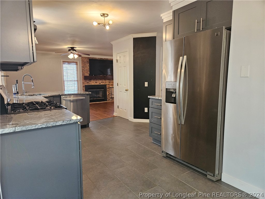 2825 Isabella Drive Raleigh, NC 27603 - Photo 10 of 31 a kitchen with granite countertop a refrigerator and a sink