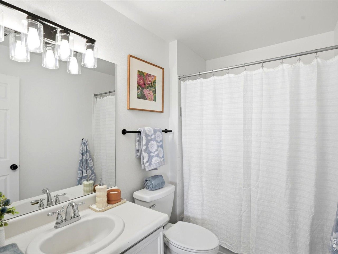 4945 Twin Lakes Road, Unit 46 Boulder, CO 80301 - Photo 24 of 42 The full guest bathroom features updated lighting and a clean, timeless design.