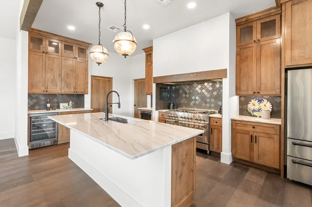 a kitchen with a sink and a clock on the wall