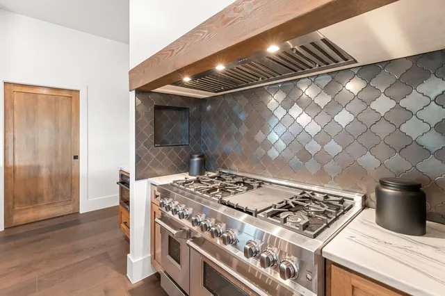 a kitchen with a sink a stove and cabinets