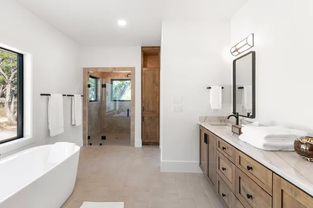 a view of a hallway with wooden floor and a ceiling fan