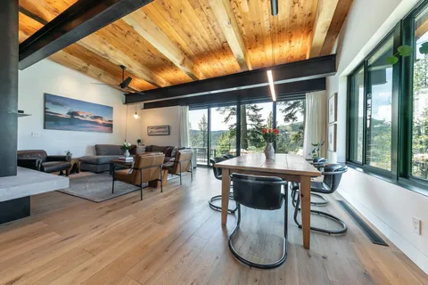 a living room with furniture a table and a large window