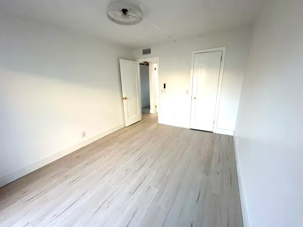 an empty room with wooden floor